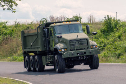 Another Load of Mack Defense Dump Trucks